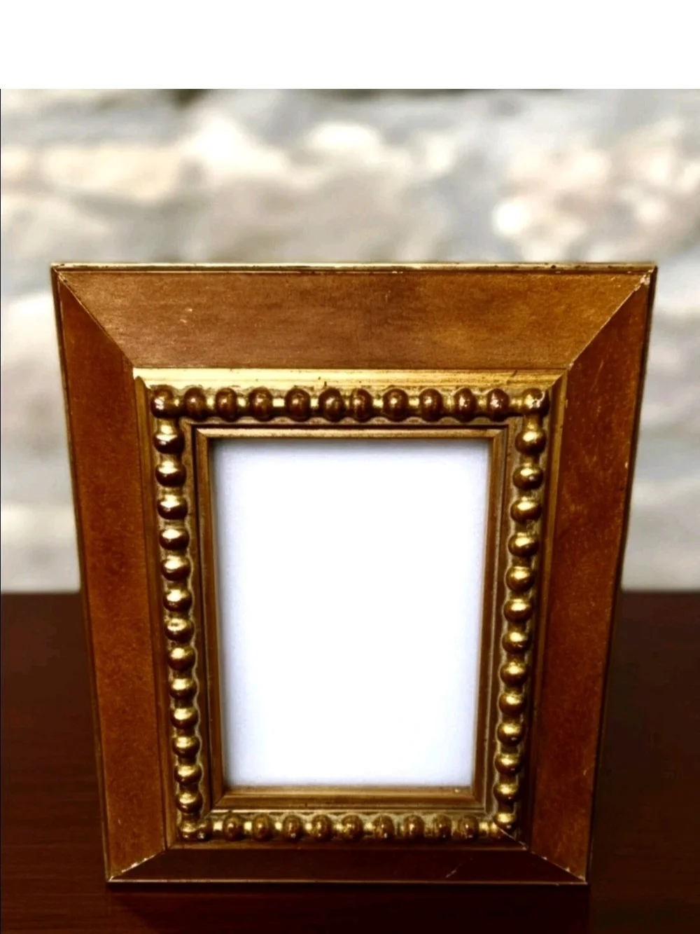 Vintage, 1980s gold-toned picture frame features a distinct beaded inner trim.